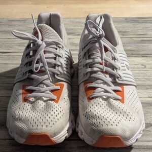 White and Orange Athletic Shoes